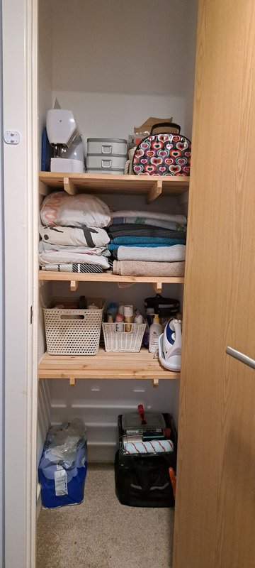 Hallway cupboard — neatly organised after