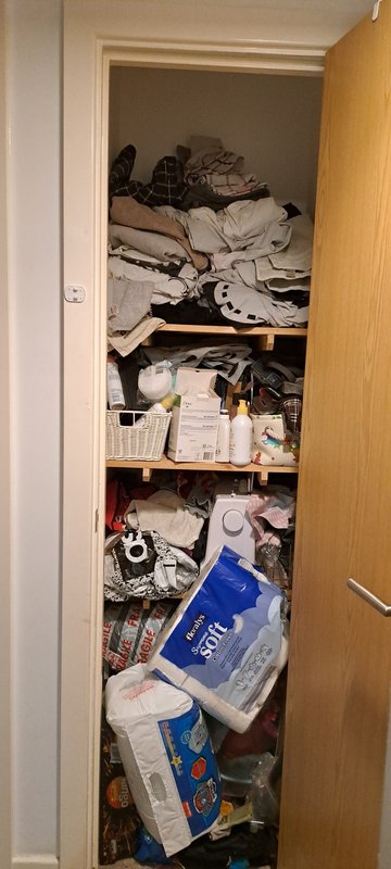 Hallway cupboard — cluttered before